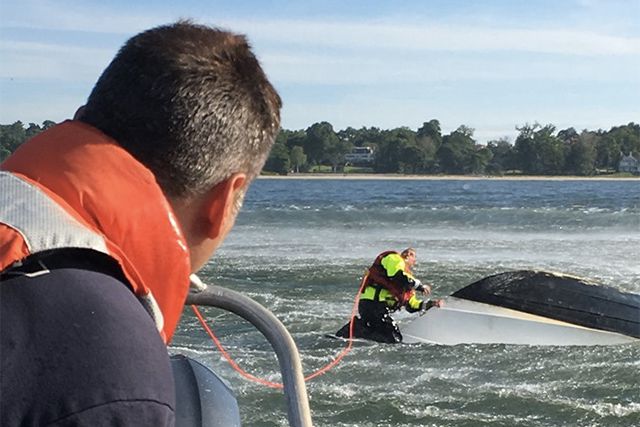 Firefighters responding to the overturned boat